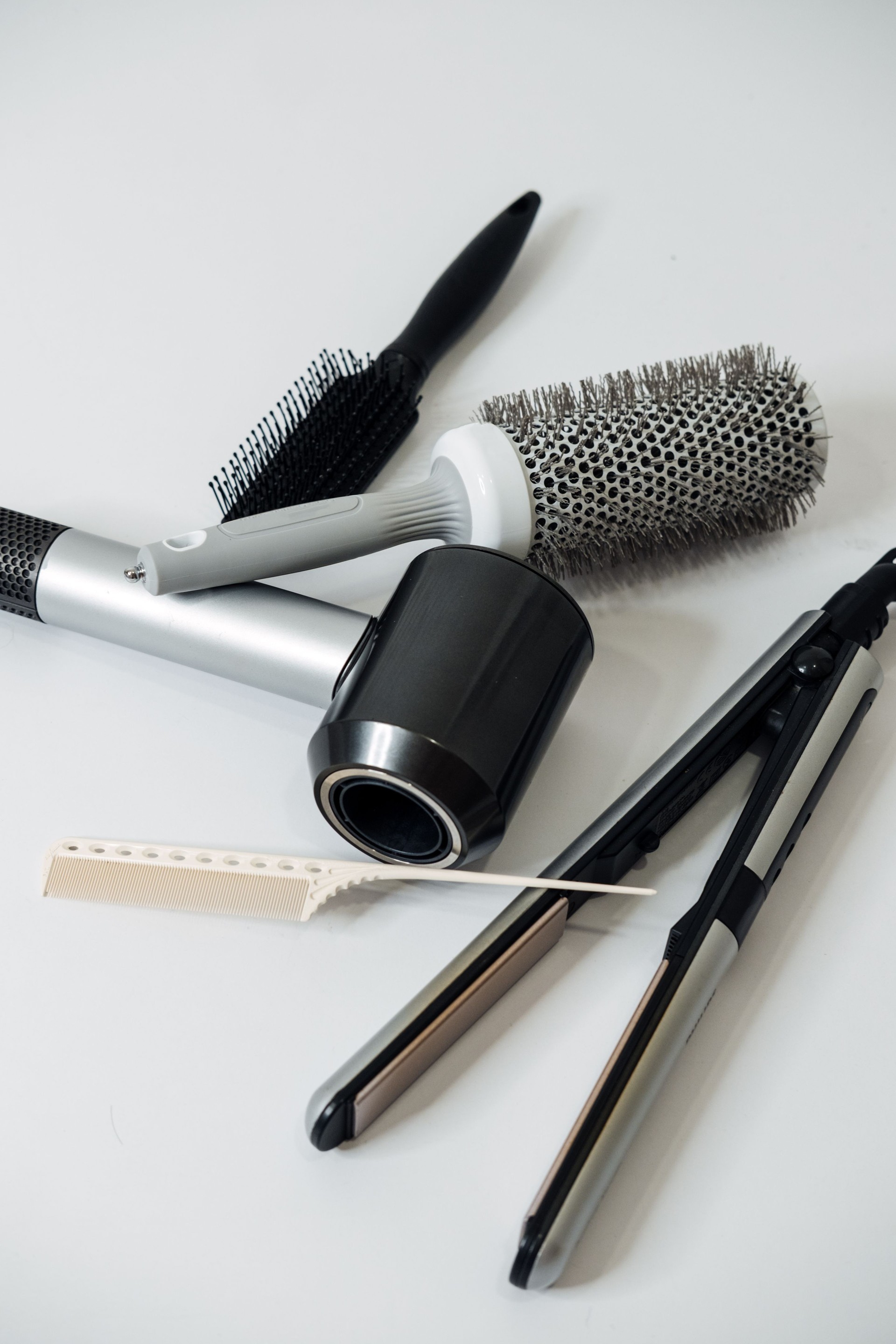 Hairdressing Tools and Equipment. Hair dryer, Paddle Brush, variety of combs, Water Bottle, Round Brush, texture iron or mini crimping iron