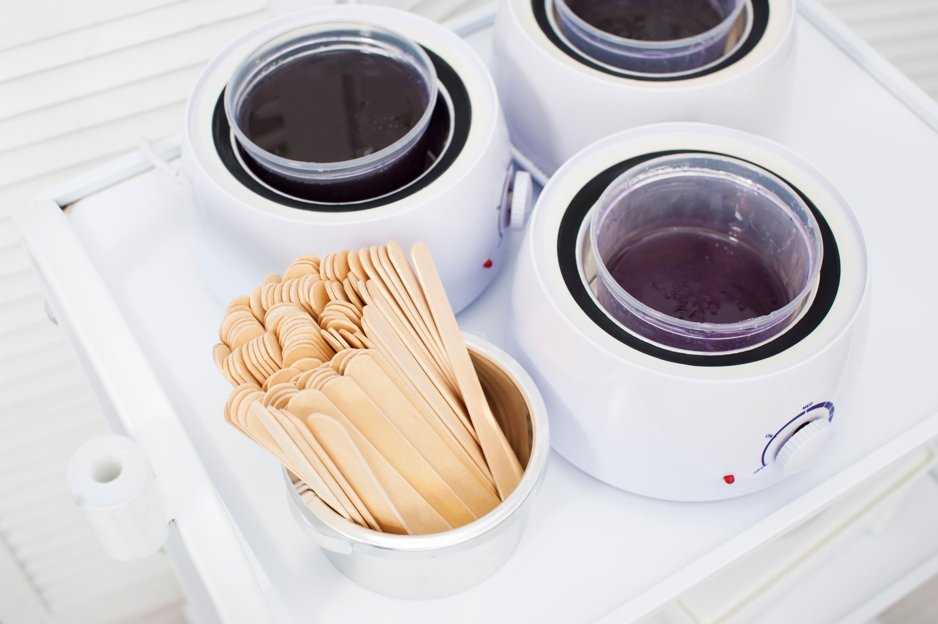 Preparing wax for shugaring. Depilatory wax close-up is heated and melted in a beauty salon. view from above